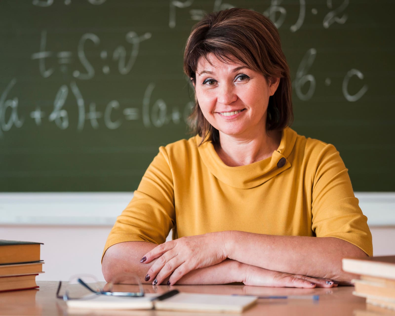 A high school teacher leading a lesson for teenage students in a classroom