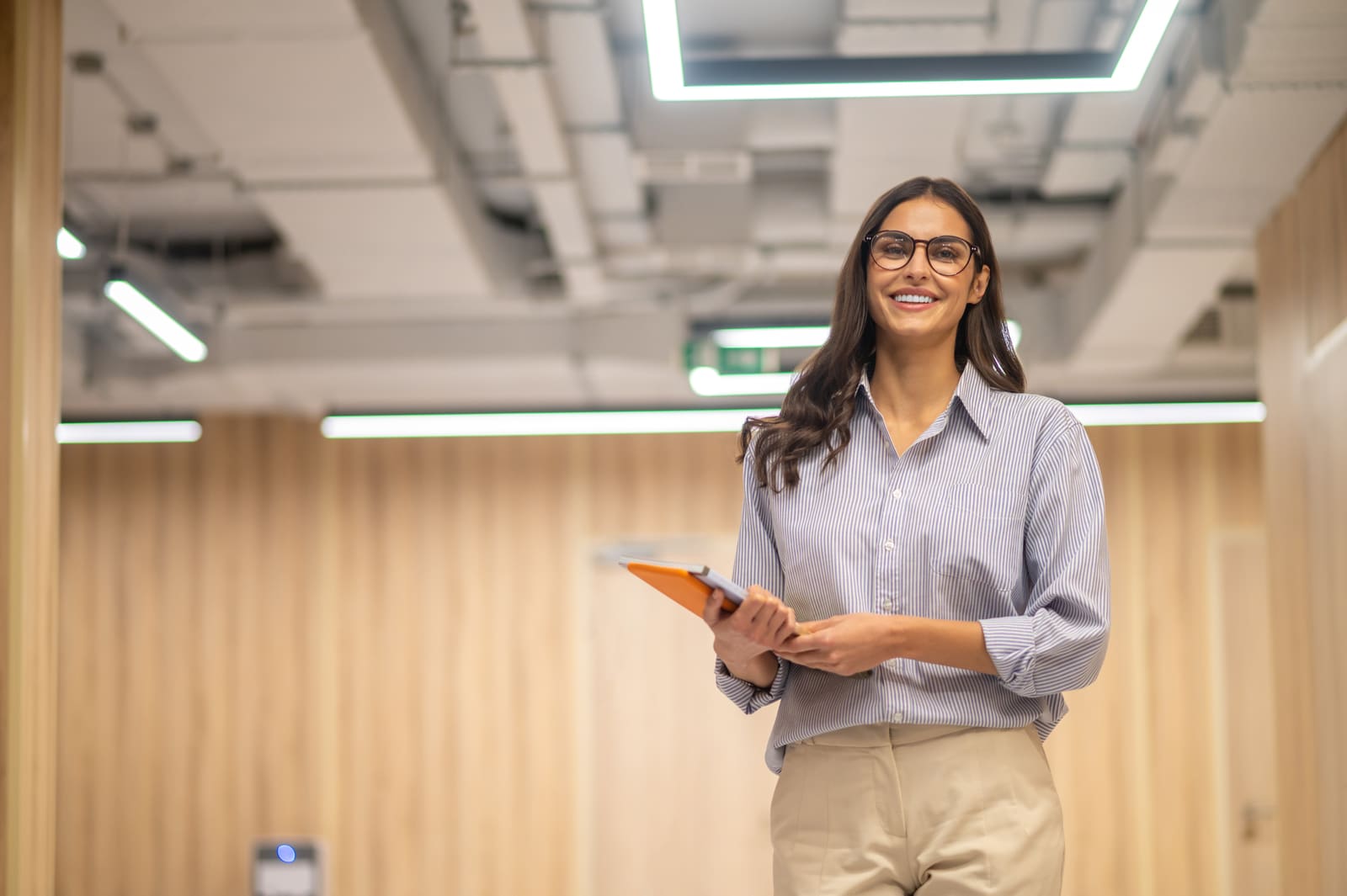 A postsecondary education teacher lecturing to students in a university classroom