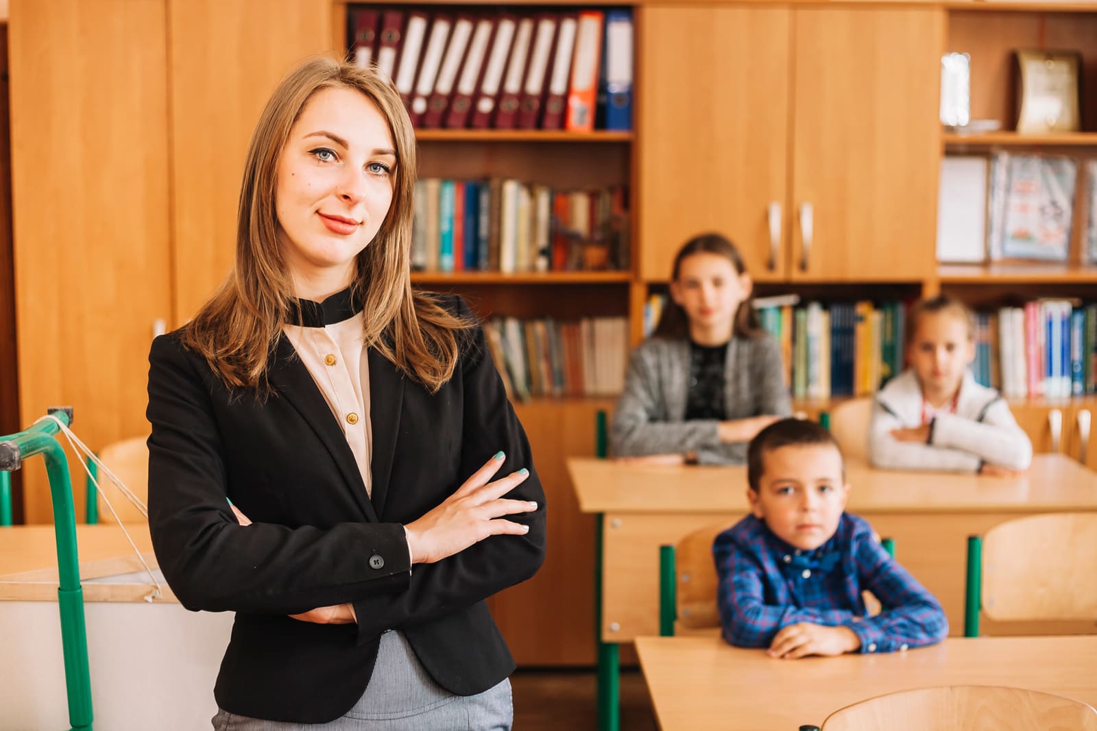 A school principal talking with students in a school hallway