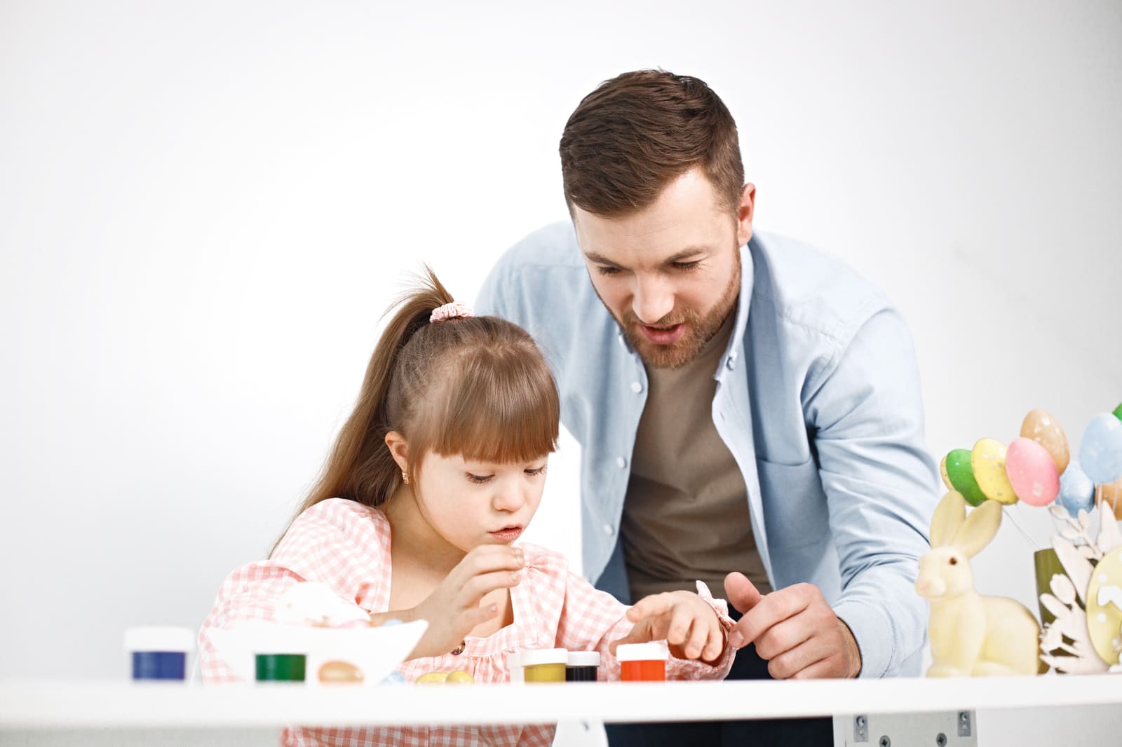 A special education teacher working one-on-one with a student in the classroom