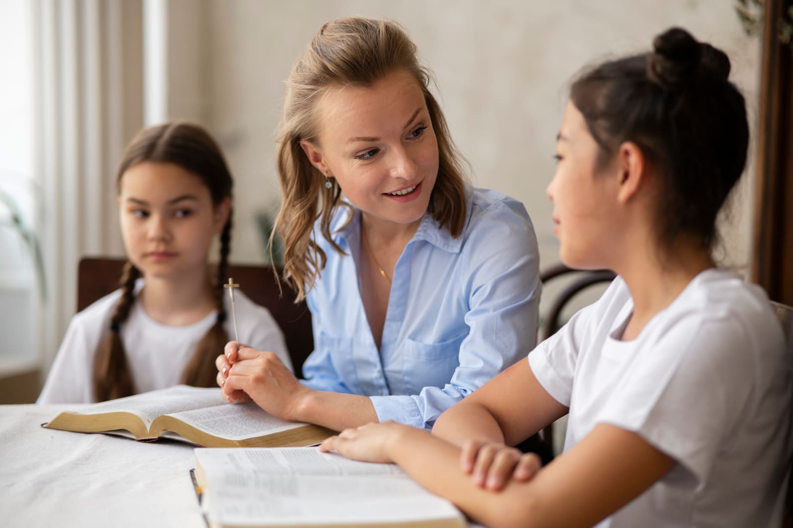 A middle school teacher working with early adolescent students at their desks