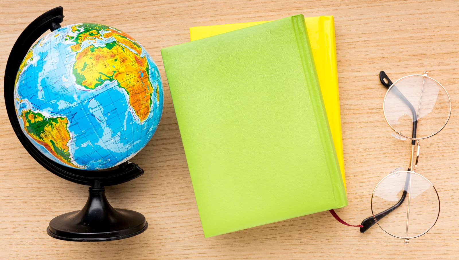 A social studies teacher pointing to a world map while teaching a class